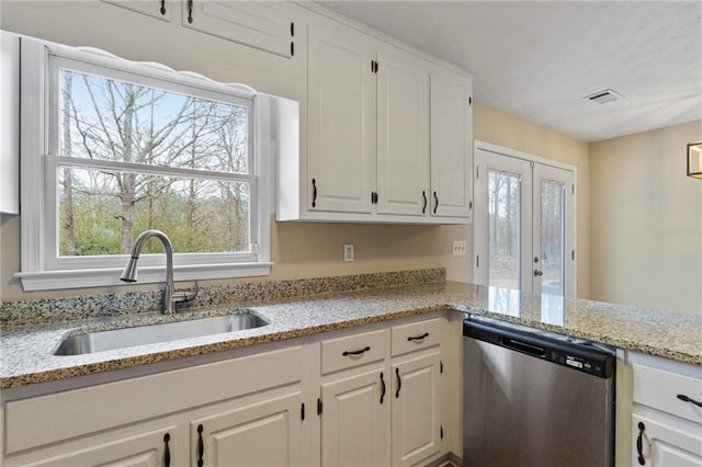 kitchen featuring white cabinetry, dishwasher, sink, and light stone counters