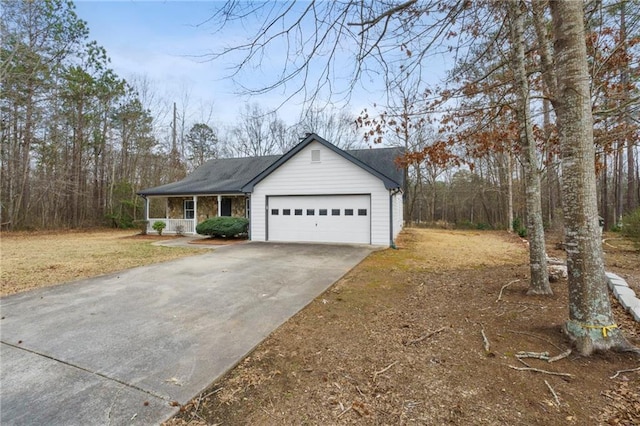 view of side of property with a garage and covered porch