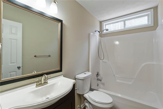 full bathroom featuring vanity, a textured ceiling, shower / bathtub combination, and toilet