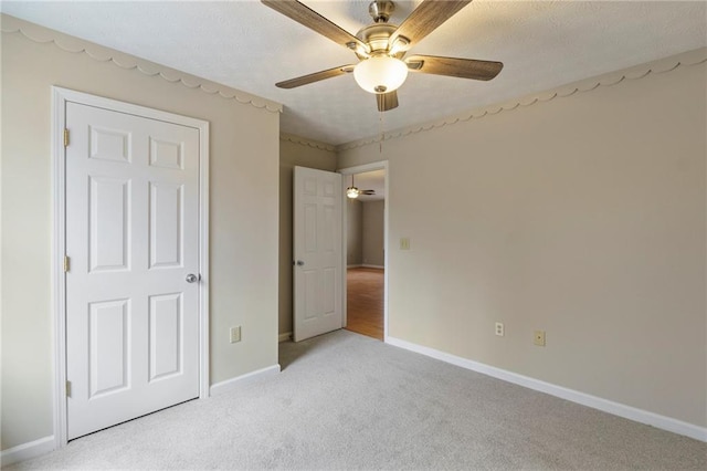 unfurnished bedroom featuring light carpet and ceiling fan