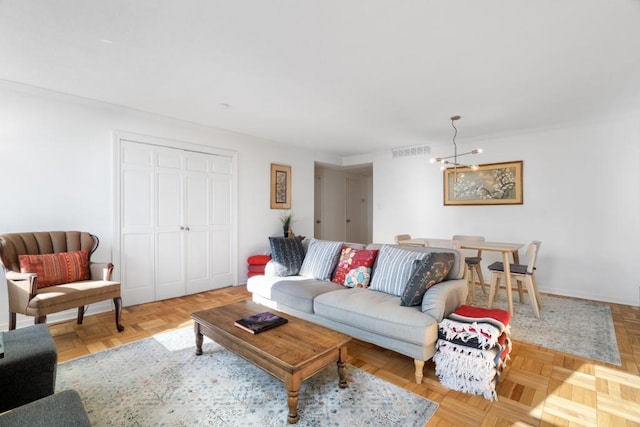 living room with light parquet flooring and a notable chandelier