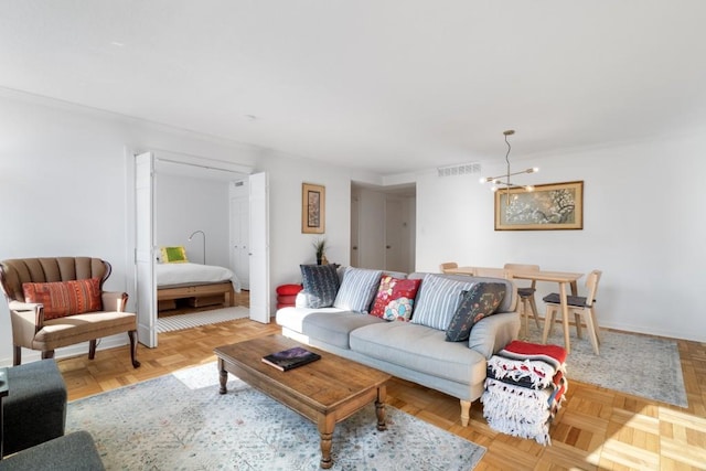 living room featuring light parquet floors and a notable chandelier