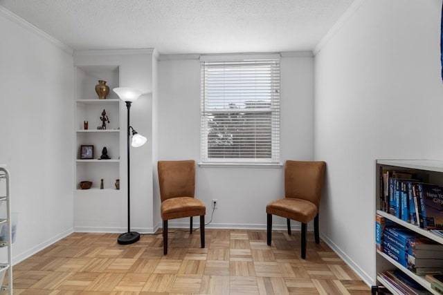 sitting room featuring a textured ceiling, crown molding, built in features, and light parquet flooring