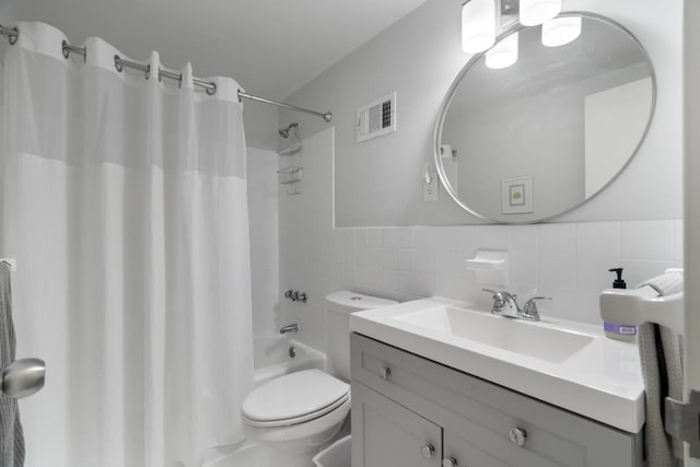 full bathroom with tile walls, tasteful backsplash, toilet, shower / bath combo with shower curtain, and vanity