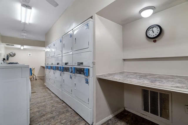 interior space with white cabinets and stacked washer and clothes dryer