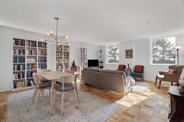 dining area with light parquet flooring and an inviting chandelier