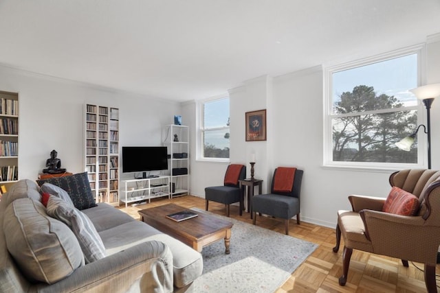 living room featuring ornamental molding and light parquet floors