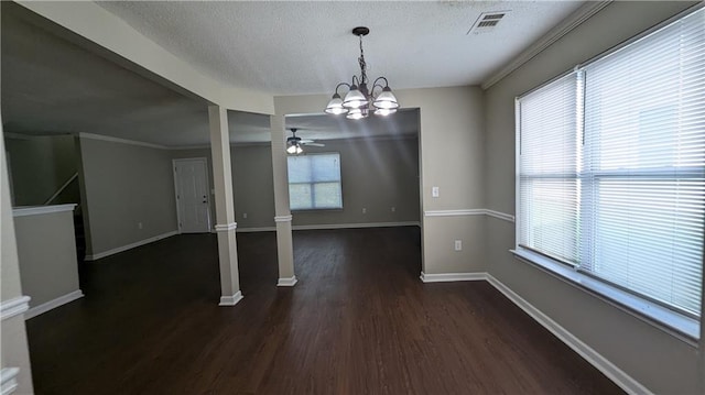 unfurnished dining area featuring ceiling fan with notable chandelier, dark hardwood / wood-style flooring, and a wealth of natural light