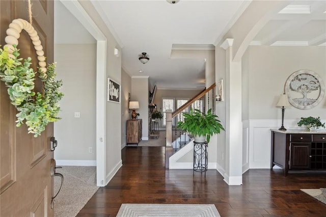 entrance foyer featuring ornamental molding and dark hardwood / wood-style floors