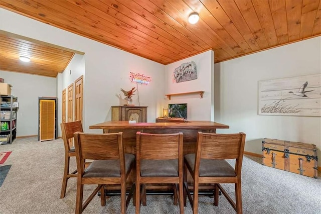 carpeted dining room with wooden ceiling