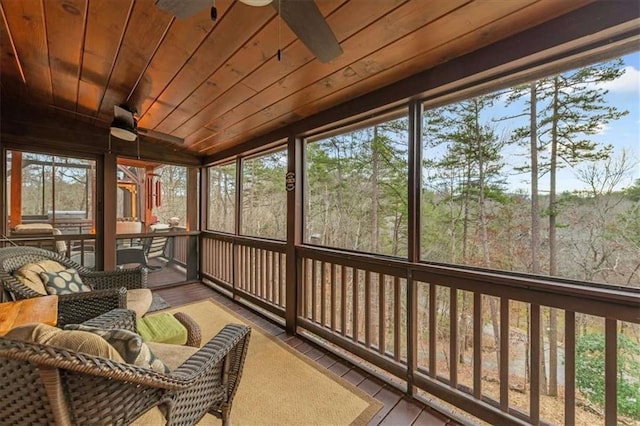 sunroom featuring wood ceiling, ceiling fan, and a wealth of natural light