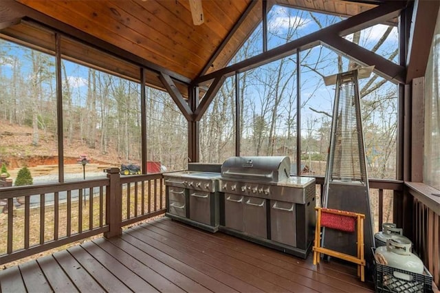 sunroom featuring wood ceiling, vaulted ceiling, and plenty of natural light