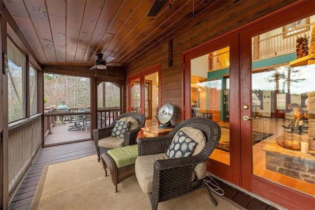 sunroom / solarium with wood ceiling and ceiling fan