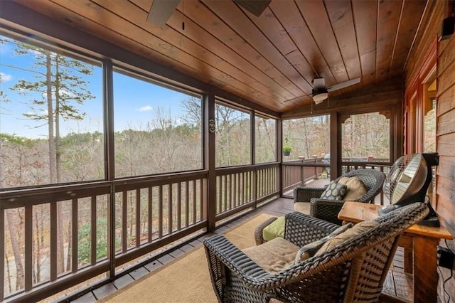 sunroom with vaulted ceiling, a wealth of natural light, and wood ceiling