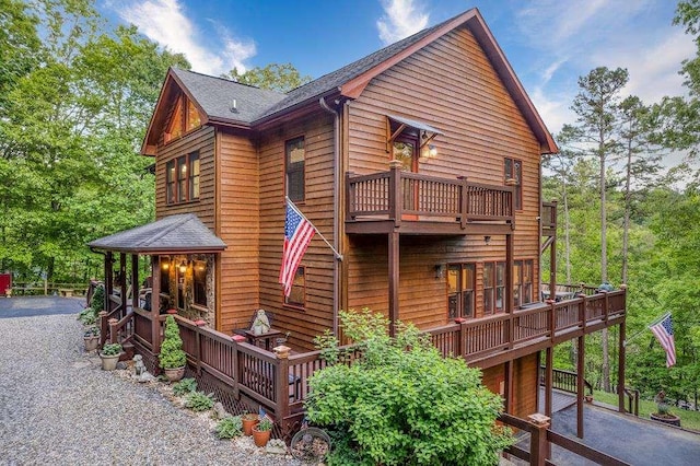 back of house featuring a balcony