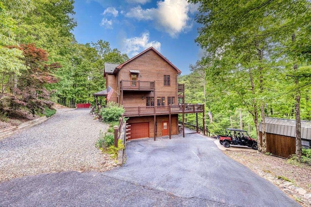 view of front of home with a garage and a balcony