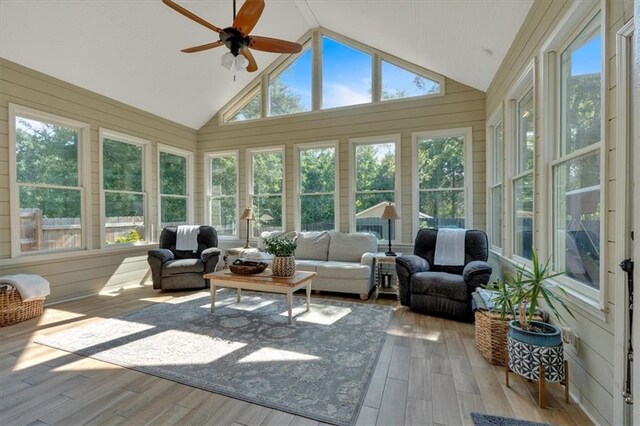 sunroom / solarium featuring lofted ceiling, a wealth of natural light, and ceiling fan