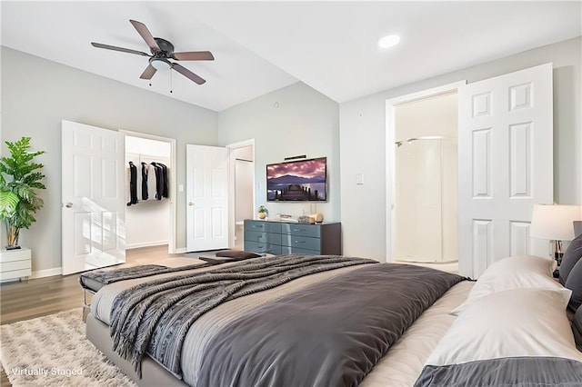 bedroom featuring a closet, hardwood / wood-style flooring, a spacious closet, and ceiling fan