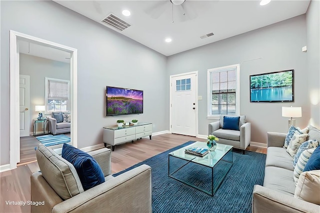 living room featuring hardwood / wood-style flooring and ceiling fan