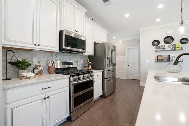 150 Azalea Xing, Dallas, GA 30132 - kitchen with stainless steel appliances, a sink, white cabinetry, light countertops, and ornamental molding