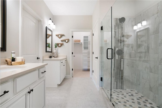 150 Azalea Xing, Dallas, GA 30132 - full bathroom featuring a shower stall, two vanities, tile patterned floors, and a walk in closet