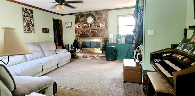 living room with ceiling fan, carpet, a fireplace, and crown molding