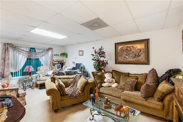 living room with carpet floors and a drop ceiling