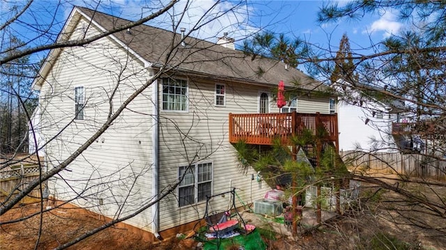 back of property featuring a wooden deck