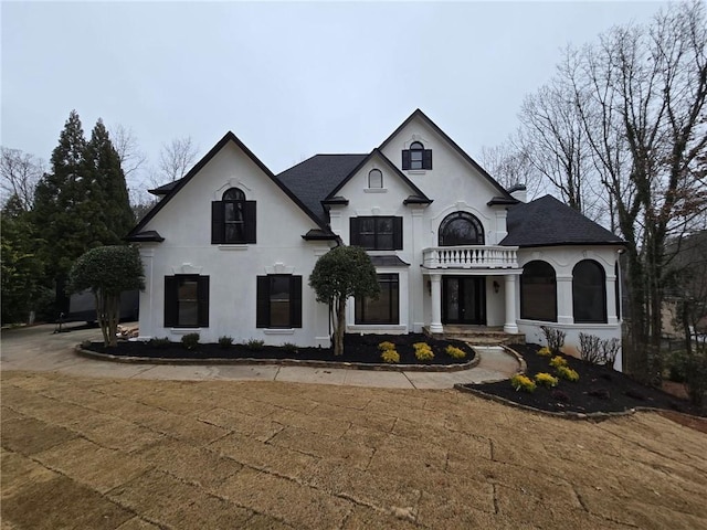 french provincial home featuring stucco siding