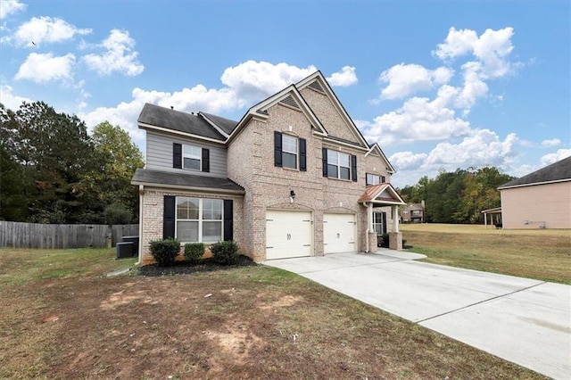 craftsman-style home with central AC unit, a garage, and a front lawn