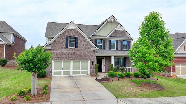 craftsman-style house featuring a garage, a front yard, and covered porch