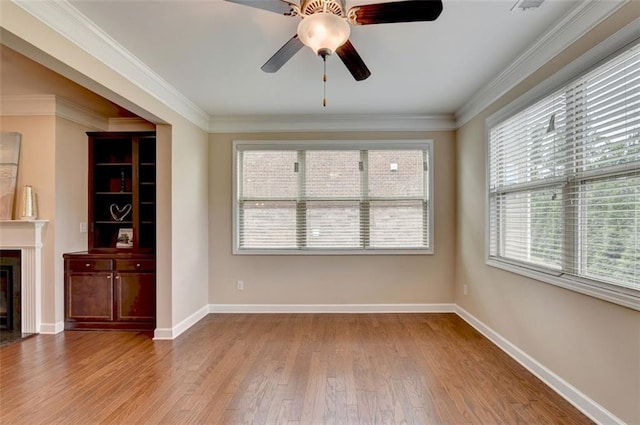 interior space with crown molding, ceiling fan, and light hardwood / wood-style flooring