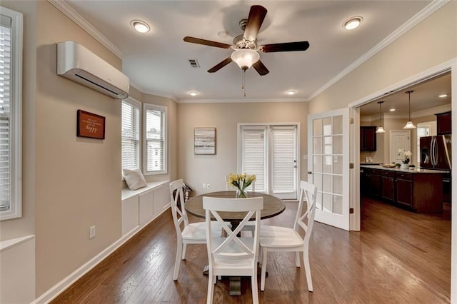 dining area featuring hardwood / wood-style floors, a wall mounted air conditioner, ornamental molding, ceiling fan, and french doors