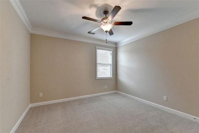 carpeted spare room with crown molding and ceiling fan