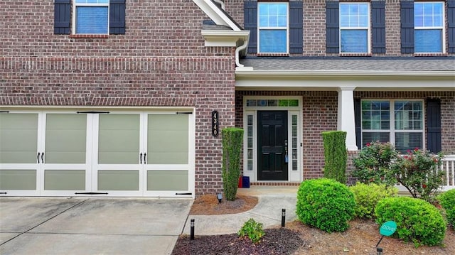 view of exterior entry with a garage