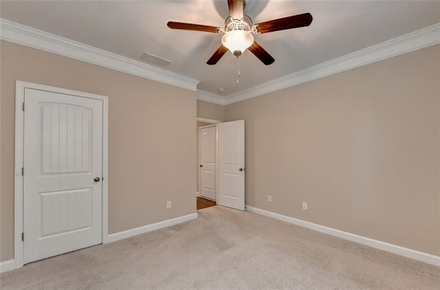 unfurnished bedroom with ornamental molding, light colored carpet, and ceiling fan