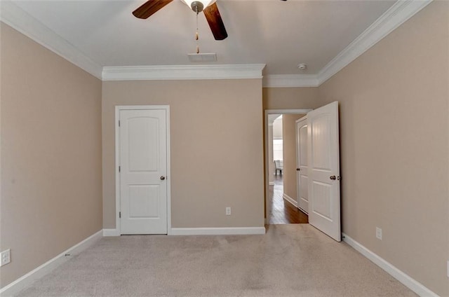 unfurnished bedroom with ceiling fan, ornamental molding, and light carpet