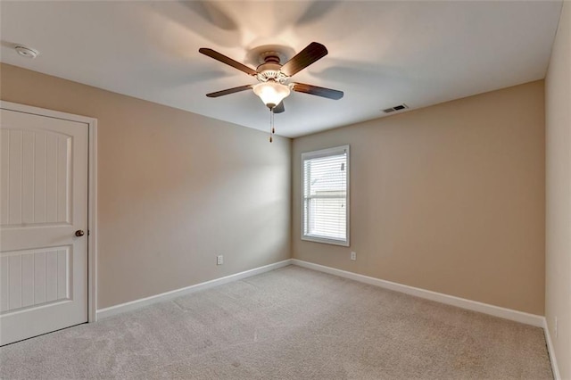 carpeted empty room featuring ceiling fan