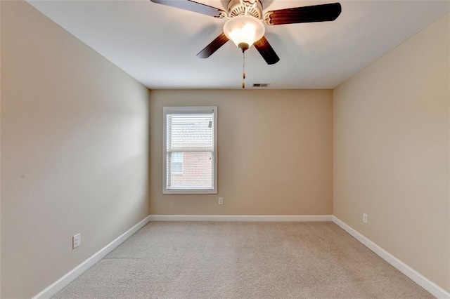 spare room with light carpet and ceiling fan