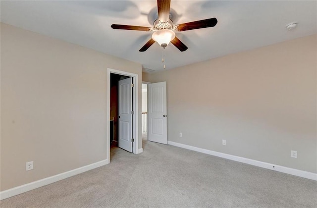 empty room with light colored carpet and ceiling fan