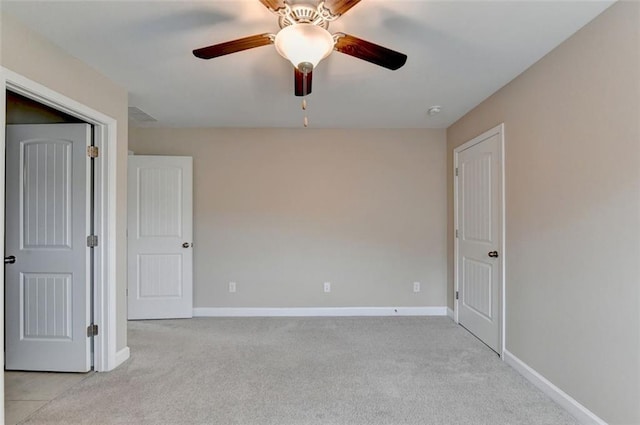 unfurnished room with ceiling fan and light colored carpet