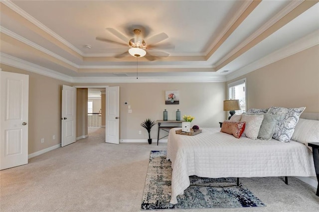 carpeted bedroom featuring ornamental molding, a raised ceiling, and ceiling fan