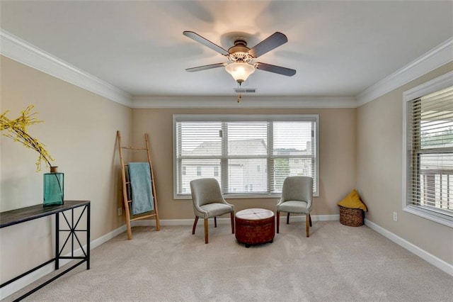 sitting room featuring light colored carpet, ornamental molding, and a wealth of natural light