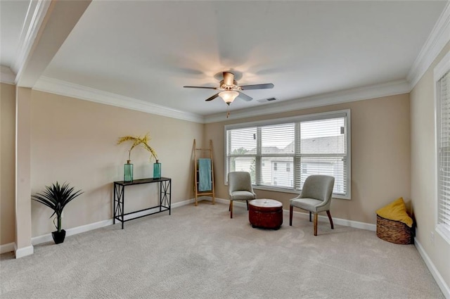 sitting room featuring light carpet, crown molding, and ceiling fan