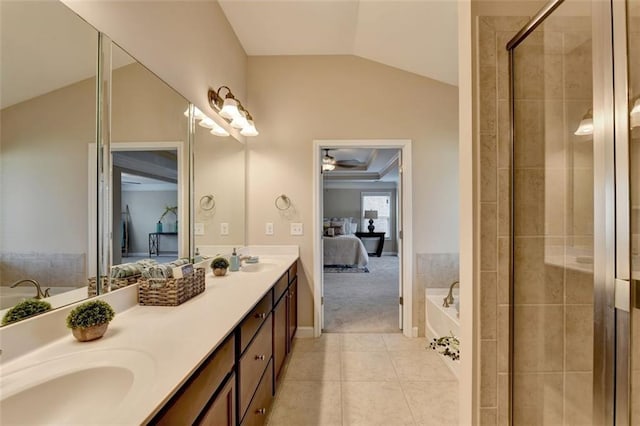 bathroom with vaulted ceiling, plus walk in shower, vanity, ceiling fan, and tile patterned floors