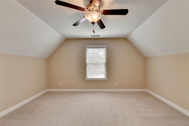 bonus room with ceiling fan, vaulted ceiling, and light carpet