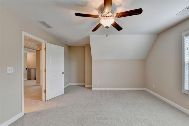 additional living space featuring light carpet and lofted ceiling