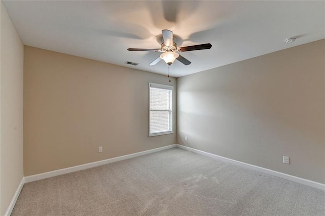 empty room featuring light carpet and ceiling fan