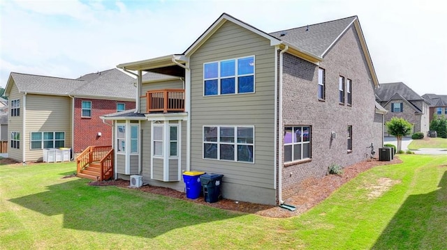 rear view of property featuring cooling unit and a yard