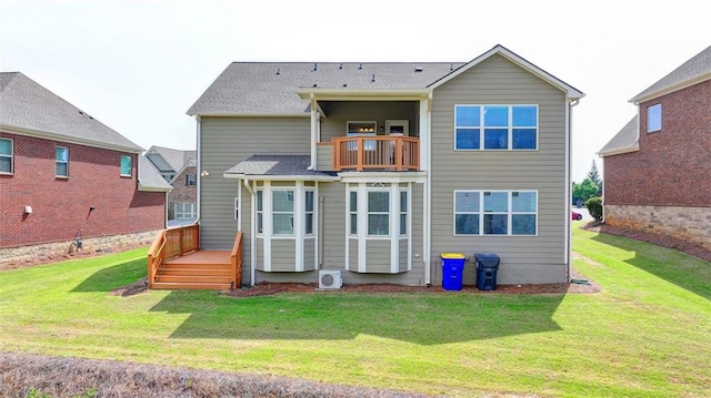 back of house featuring a yard and a balcony